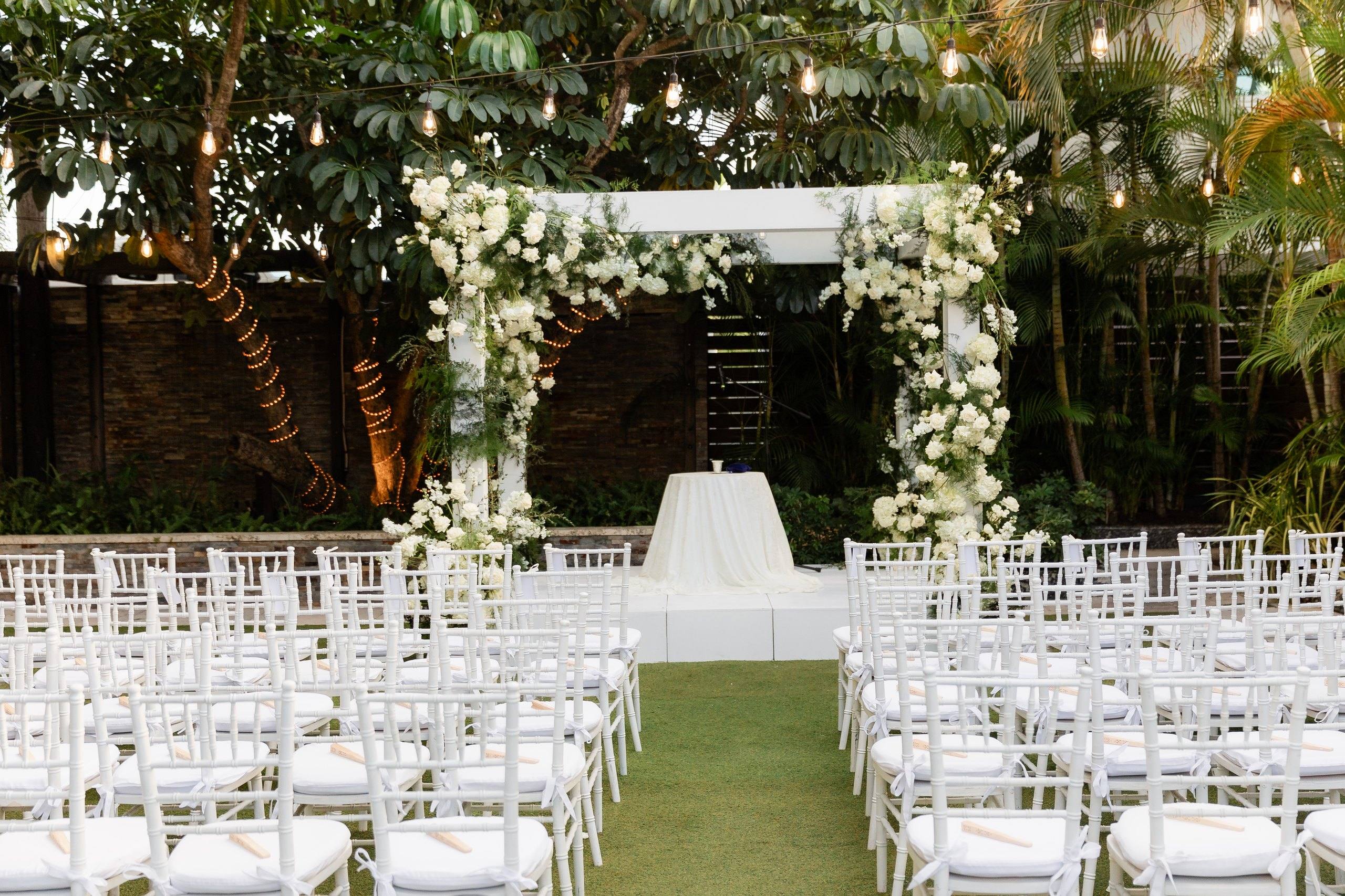 Four post canopy with white fabric in a garden