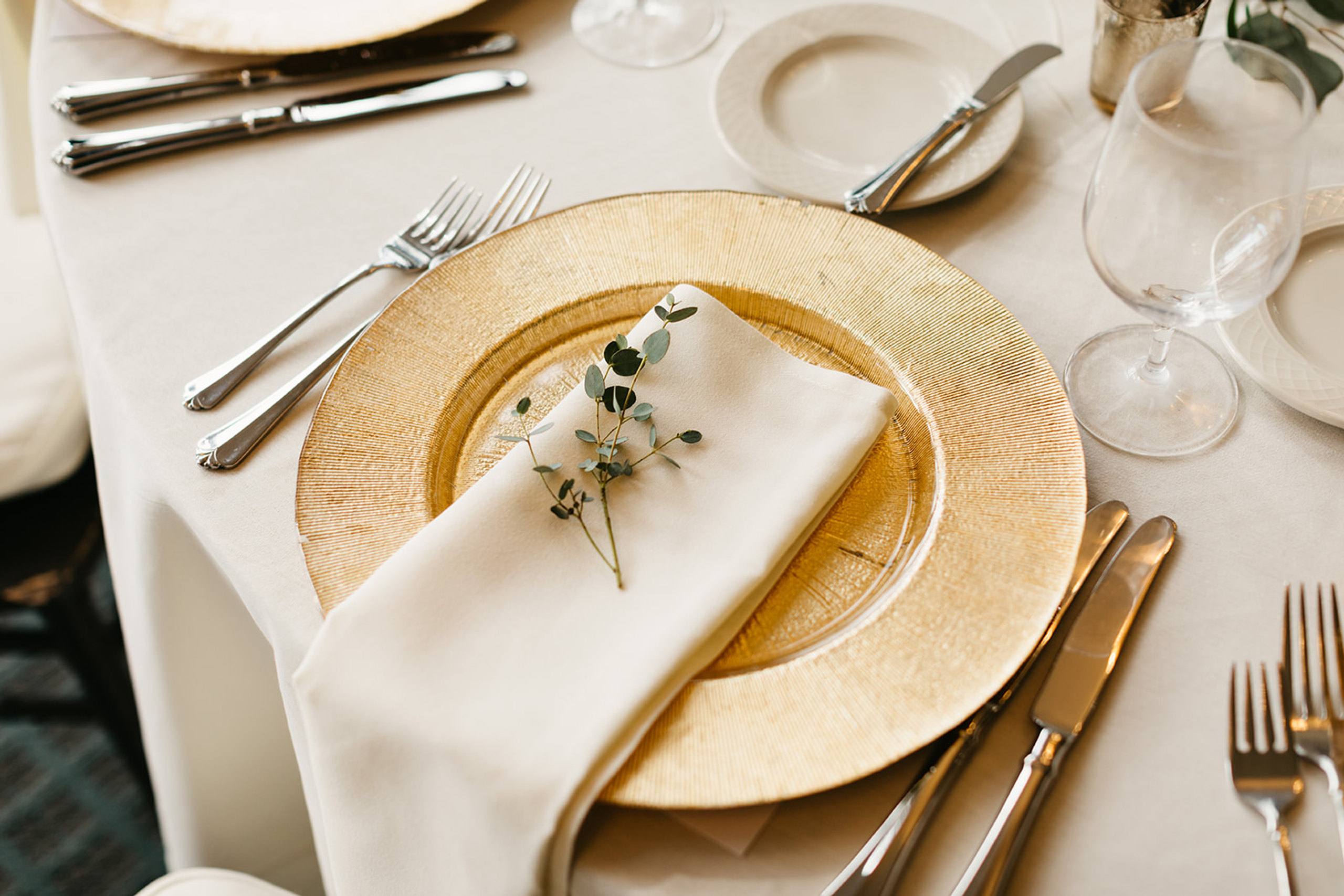 Gold charger place setting with bright flowers