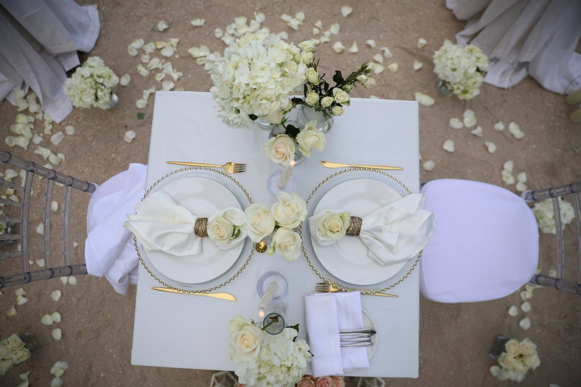 Overhead view of a table for two with flowers and candles