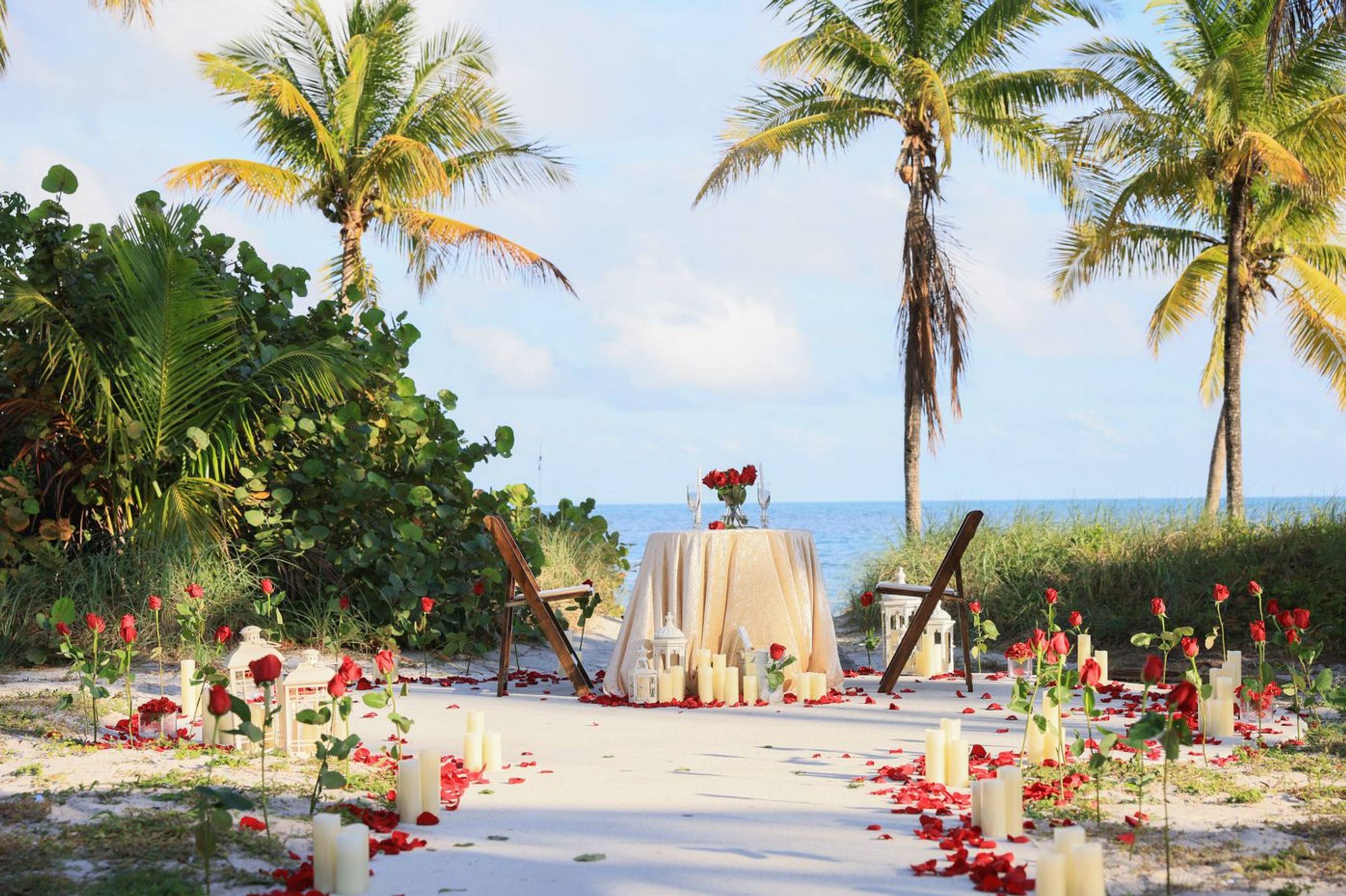 Palm-lined beach aisle with bright flowers