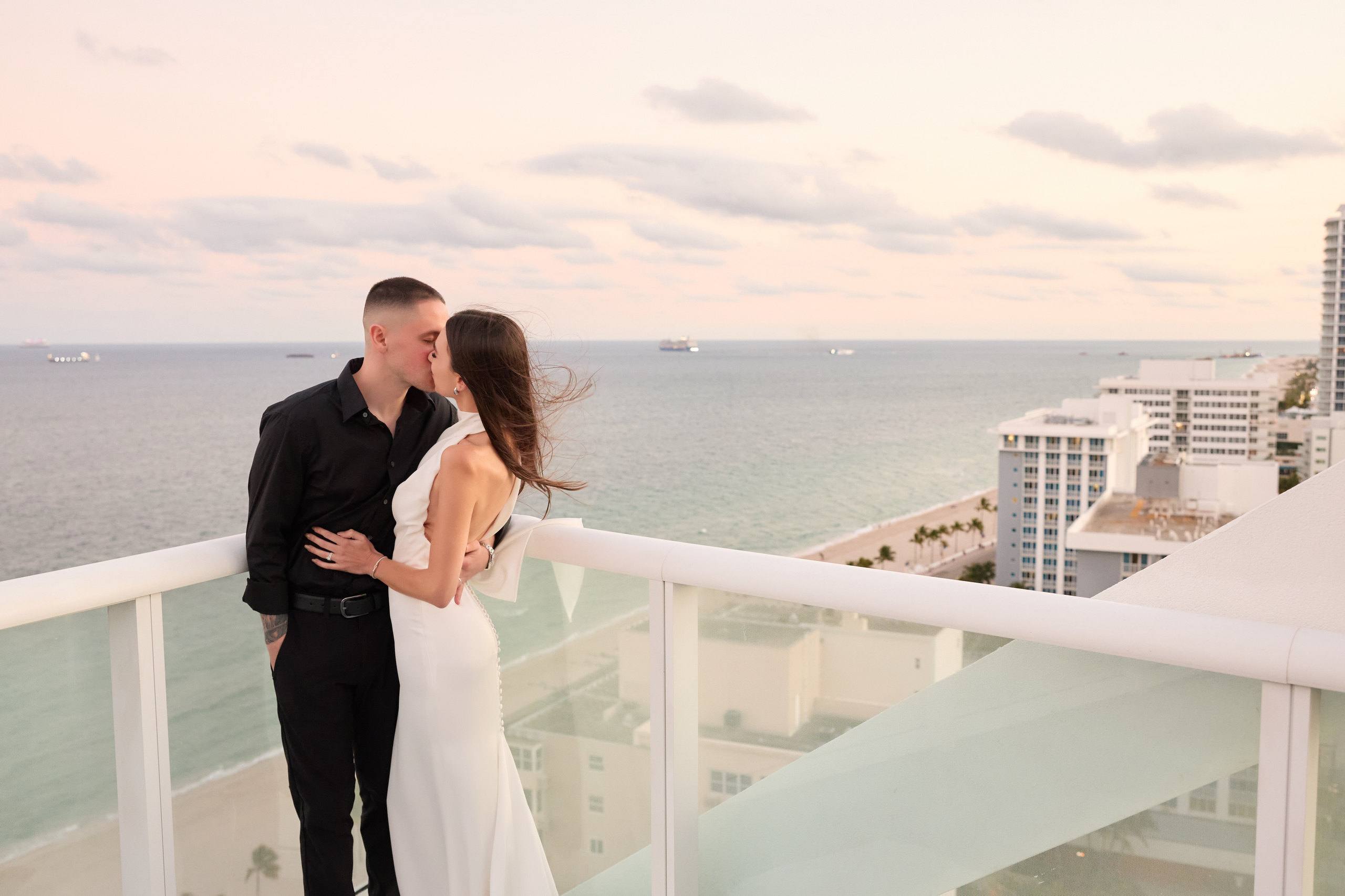 Couple on a rooftop above the pastel evening skyline